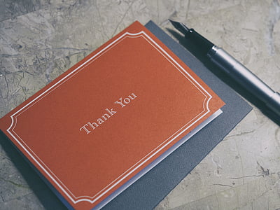 brown book beside fountain pen thumbnail