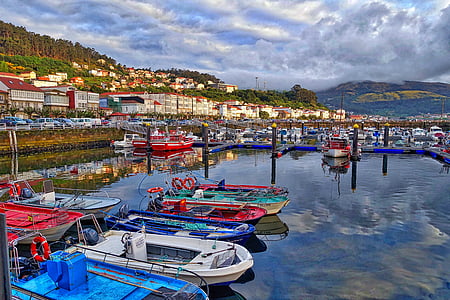 white, blue, and red boats in body of water thumbnail