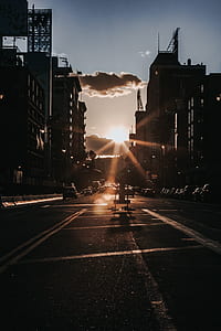 vehicle parked near building under white cloud and blue sky thumbnail