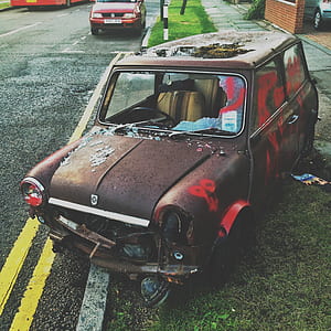 classic brown coupe on road at daytime thumbnail