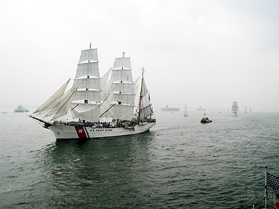 white vessel on body of water with mist at daytime thumbnail