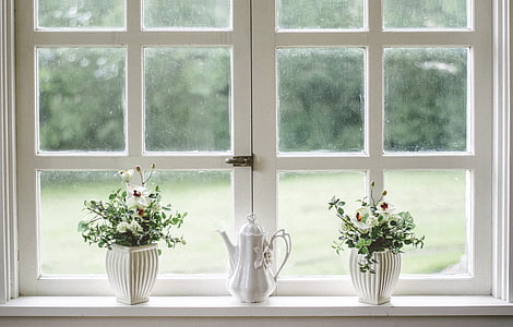 two white ceramic vases beside window pane thumbnail