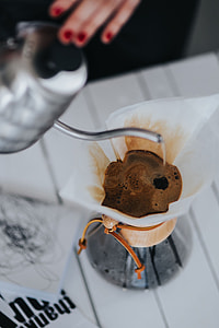 Woman pouring water in Chemex filter coffee maker thumbnail