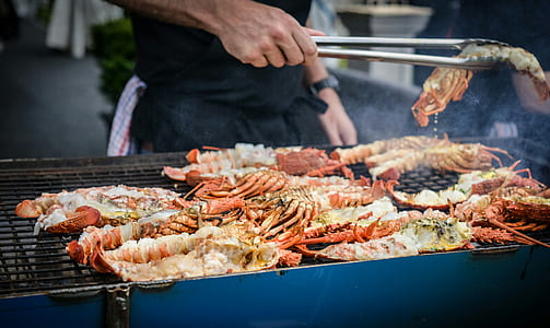 person grilling prawns thumbnail
