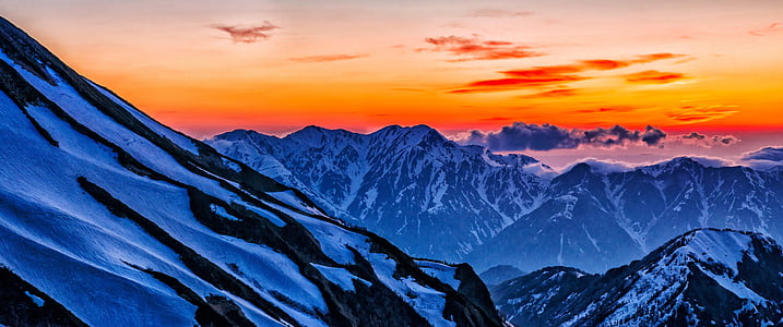 aerial photography of snow-covered mountains during golden hour thumbnail