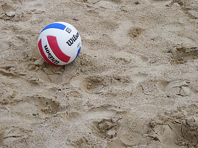 white and red Wilson volleyball on sand thumbnail