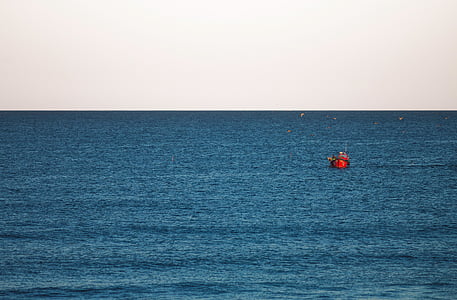 red boat on the ocean photography thumbnail