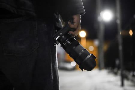 person holding black DSLR camera thumbnail