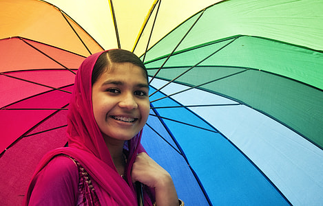 woman holding multi-colored umbrella thumbnail