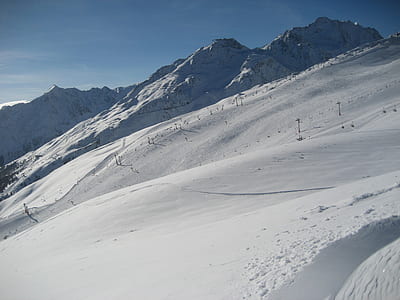 photography of snow coated mountain under blue sky at daytime thumbnail