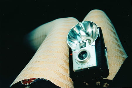 black and gray camera on person's lap thumbnail
