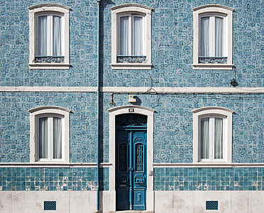 blue and white concrete building during daytime thumbnail