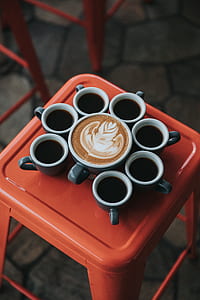 cappuccino coffee on gray mug surrounded black black coffee thumbnail