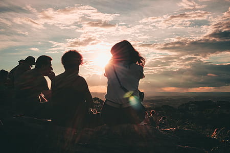Group of People Sitting on Hill thumbnail