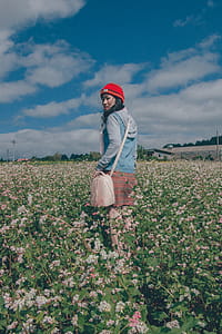 Woman Wearing Red Knit Hat and Blue Hoodie Jacket thumbnail
