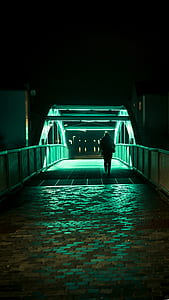person walking on bridge at daytime thumbnail