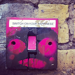 red and black switch on beige concrete wall thumbnail