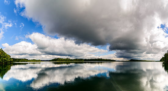 body of water near green leaf trees thumbnail