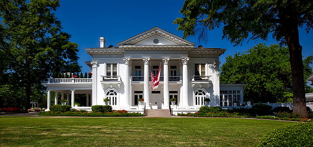 white building near trees at daytime thumbnail