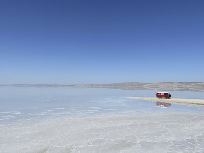 red vehicle on shore at daytime thumbnail