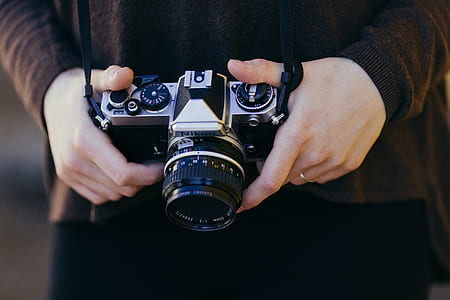 person holding black and grey camera at daytime thumbnail