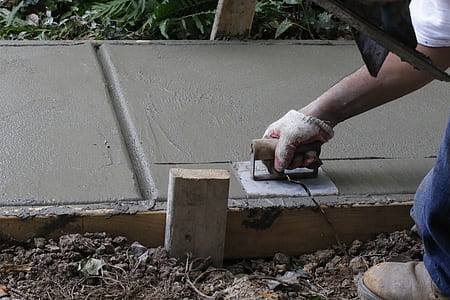 person planes wet concrete with trowel thumbnail