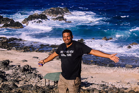 Photography of Man in Black Shirt Near Body of Water thumbnail