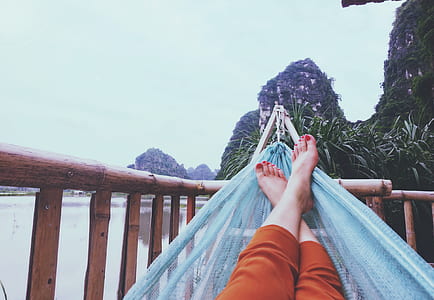 woman laying down on blue hammock thumbnail