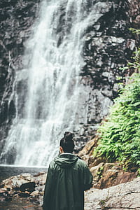woman standing near waterfalls thumbnail