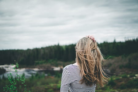 woman holding her head facing plant thumbnail