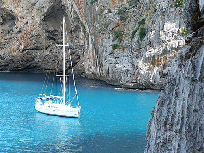 white boat in the center of the shore during daytime thumbnail