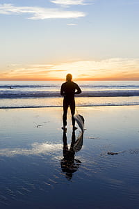 person standing facing seashore thumbnail