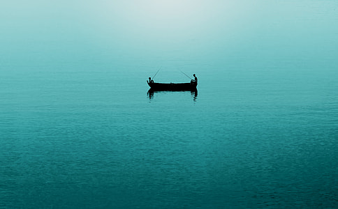 man on boat on body of water at daytime thumbnail