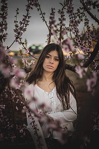 woman standing near pink flowers thumbnail