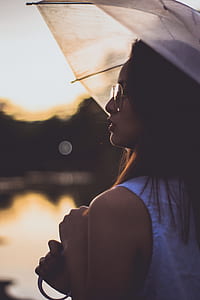 woman with umbrella in shallow-focus shot thumbnail