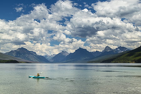 person on kayak under cloudy sky thumbnail