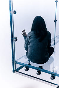 woman sitting beside the window thumbnail