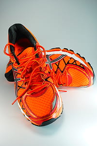 pair of orange-and-white ASICS running shoes thumbnail