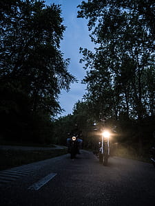 Two Men Riding Motorcycle on Road during Nighttime thumbnail