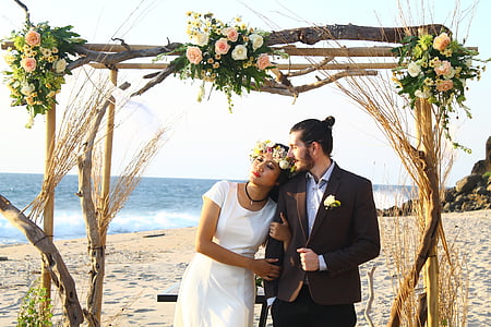 photo of bride and groom on seashore during daytime thumbnail