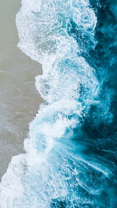 timelapse photography of waves splashing on shore thumbnail