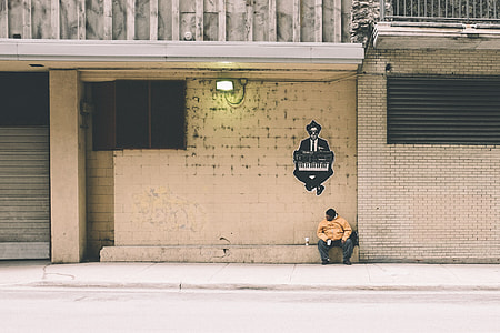 minimalist photography of man sitting on wall with man playing piano mural painting thumbnail