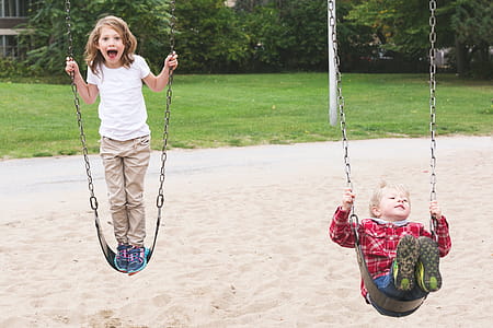 Brother & Sister On Swings Photo thumbnail