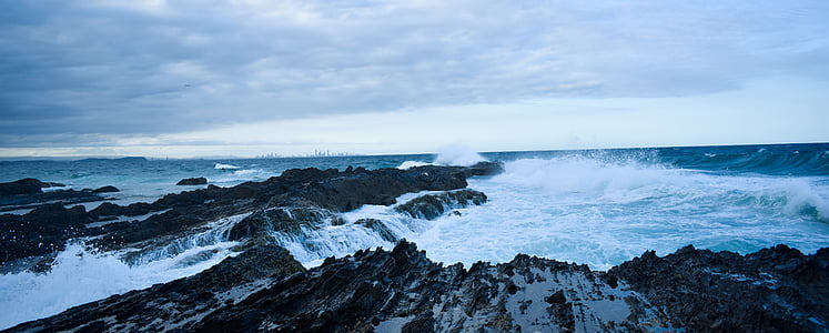aerial photography of sea waves splashing on cove at daytime thumbnail