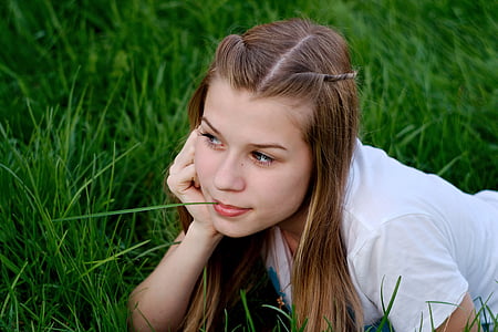 woman lying on lawn wearing white shirt thumbnail