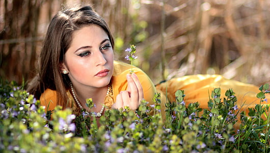 woman lying on grass field selective focus photo thumbnail