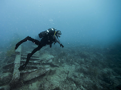man scuba diving in deep sea thumbnail