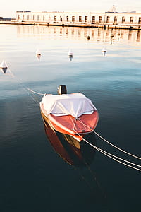 red and white boat on water thumbnail