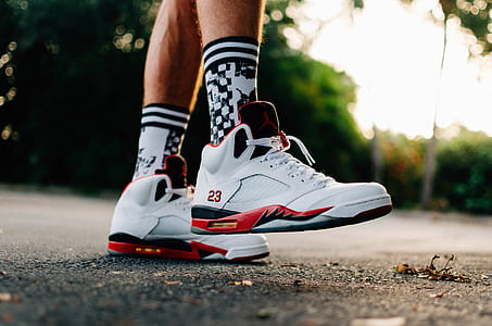 person wearing pair of fire red Air Jordan 5's thumbnail