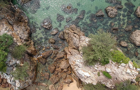 rock formation near body of water thumbnail
